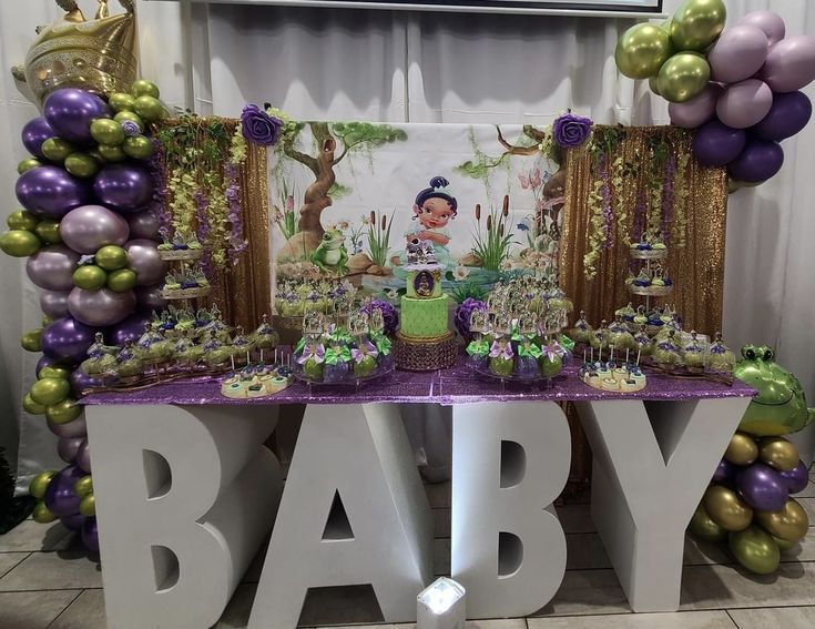 a baby shower party with purple and green decorations