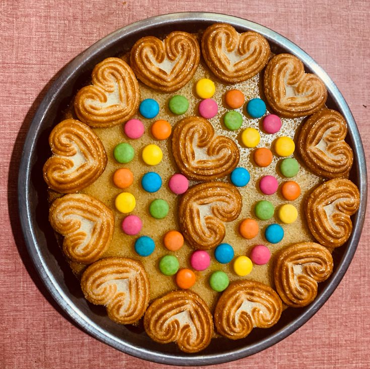 a pan filled with cookies and candy on top of a table