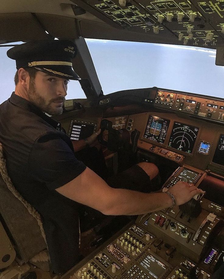 a man sitting in the cockpit of an airplane looking at the control board and pilot