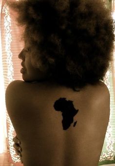 the back of a woman's body with a map tattoo on her left side