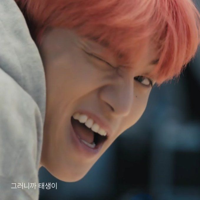 a close up of a person with red hair and an open mouth wearing a hoodie