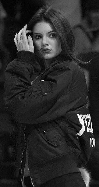 black and white photograph of a woman with her hand on her head while talking on the phone