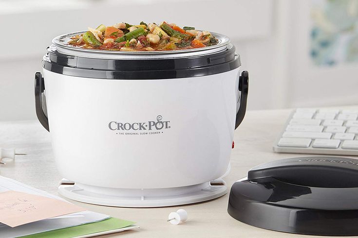 a crock pot sitting on top of a desk next to a keyboard and mouse