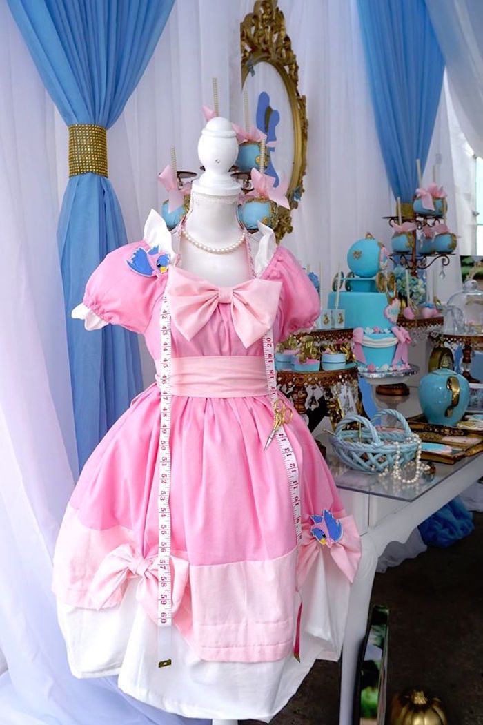 a pink and white dress sitting on top of a table