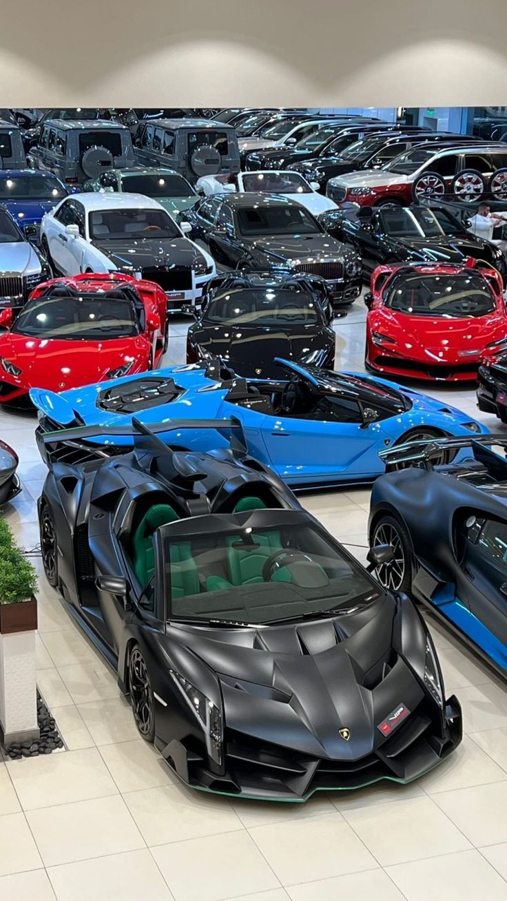 a bunch of cars that are parked in a room with tile flooring and white walls