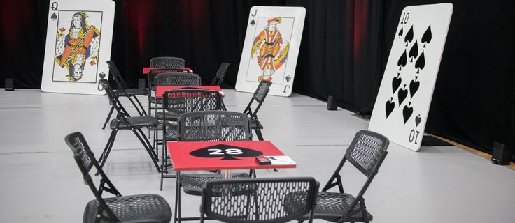 tables and chairs are lined up in front of black curtains