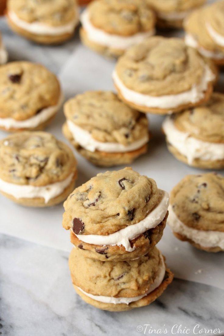 chocolate chip cookies and cream sandwich sandwiches on a marble counter top with white icing