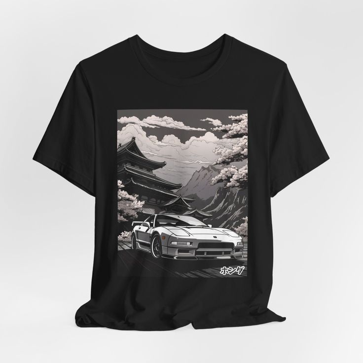 a black t - shirt with an image of a car in front of mountains and clouds