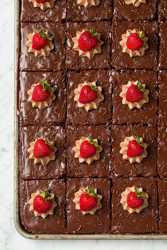 chocolate squares with strawberries on top are arranged in the shape of hearts and flowers