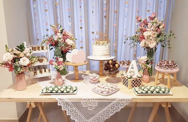 a table topped with lots of cakes and desserts