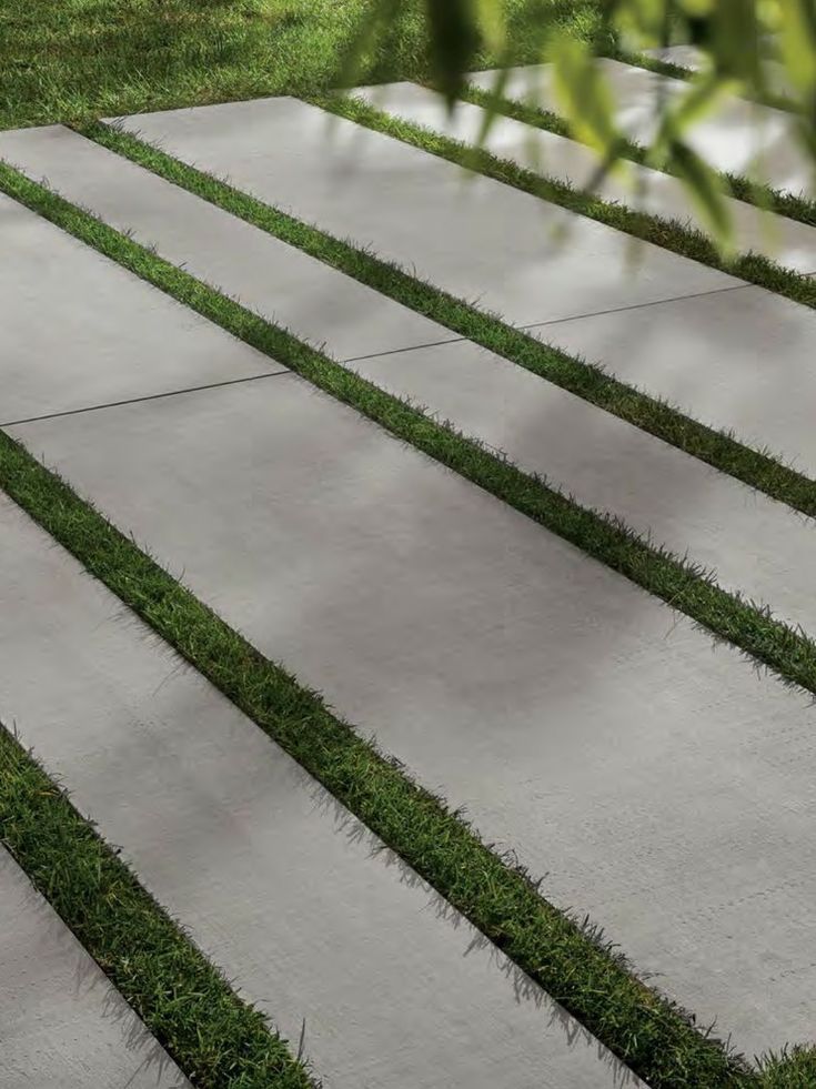 an outdoor area with grass and concrete steps