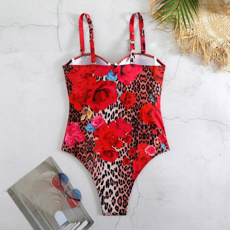 Unleash your wild side with our Leopard & Floral Lace-Up Swimsuit. This stunning one-piece features a bold mix of leopard and floral prints, perfect for making a statement at the beach or pool. The underwire design provides excellent support and shape, while the removable shoulder straps offer versatile styling options. The lace-up front adds a touch of allure and allows for a customizable fit. Fully lined for added comfort and coverage, this swimsuit ensures you feel confident all day long. Mad Red Stretch Swimwear With Floral Print, Red Tropical Printed Swimwear, Red Floral Print One-piece Swimwear, Pink Floral Print V-neck Swimwear, Stylish Headbands, Summer Leopard Print Swimwear With Built-in Bra, Summer Earring, Crochet Crop Top, Beautiful Summer