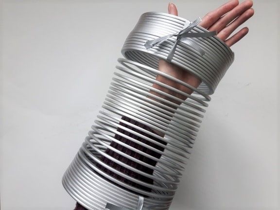 a person's hand is wrapped in tin cans