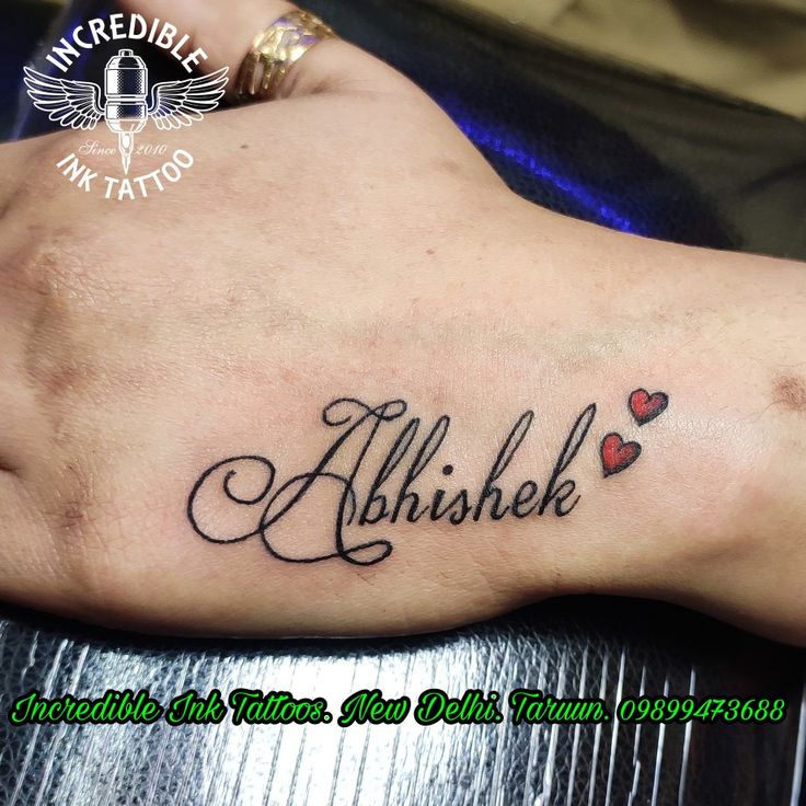 a foot tattoo with the words albuske and hearts in cursive font