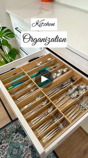 an open drawer with utensils and spoons in it