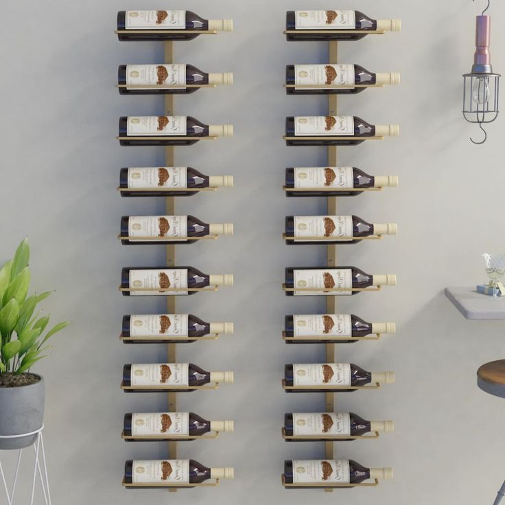 there are many bottles of wine on the wall next to a potted green plant