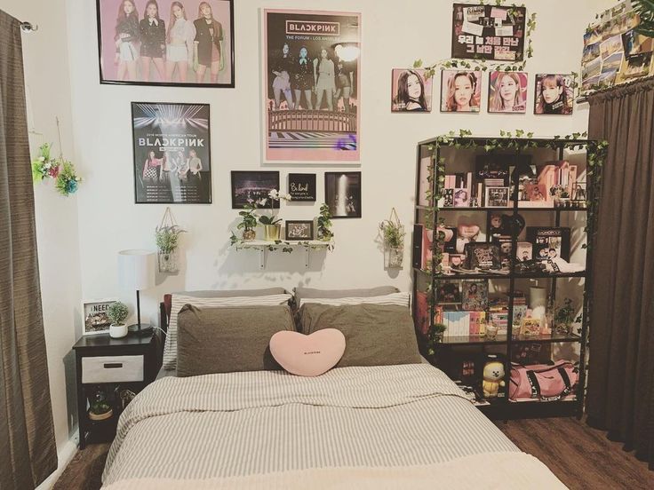 a bedroom with pictures on the wall and a bed in front of a bookcase