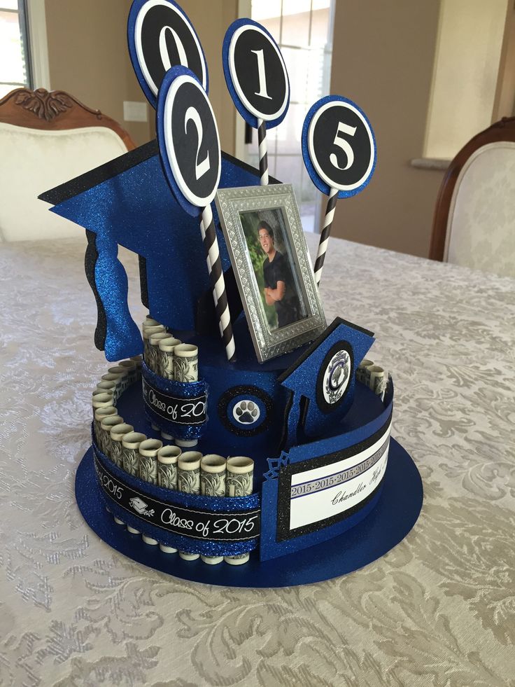 a cake made to look like a graduation hat with money in it and the number five on top