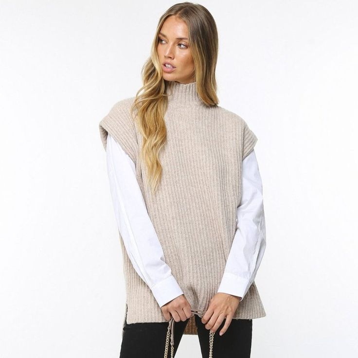 Get A Cool Layered Look This Season With The Ganni Rib Knit Vest. Made Of 70% Certified Recycled Wool To Reduce Waste, Air And Soil Pollution And Generate Lower Co2 Emissions, This Eco-Conscious Piece Is Sustainable As Well As Stylish. This Boxy Knit Features A Mock Neck, Dropped Shoulders And Side Slits, With A Ribbed Knit Design For A Chic Aesthetic. 60% Recycled Wool, 18% Polyamide, 10% Wool, 7% Recycled Polyamide, 5% Other Fibres Side Slits Hand Wash I Am 5'6, 130 Lbs, And Wear A Size Small Chunky Knit Top For Winter Workwear, Winter Chunky Knit Tops For Work, Cozy Sweater Vest For Winter Workwear, Beige Ribbed Sweater Vest For Fall, Winter Turtleneck Sweater Vest For Layering, Cozy Chunky Knit Workwear Tops, Cozy Chunky Knit Tops For Work, Chunky Knit Sweater Vest For Winter, Winter Chunky Knit Sweater Vest For Layering