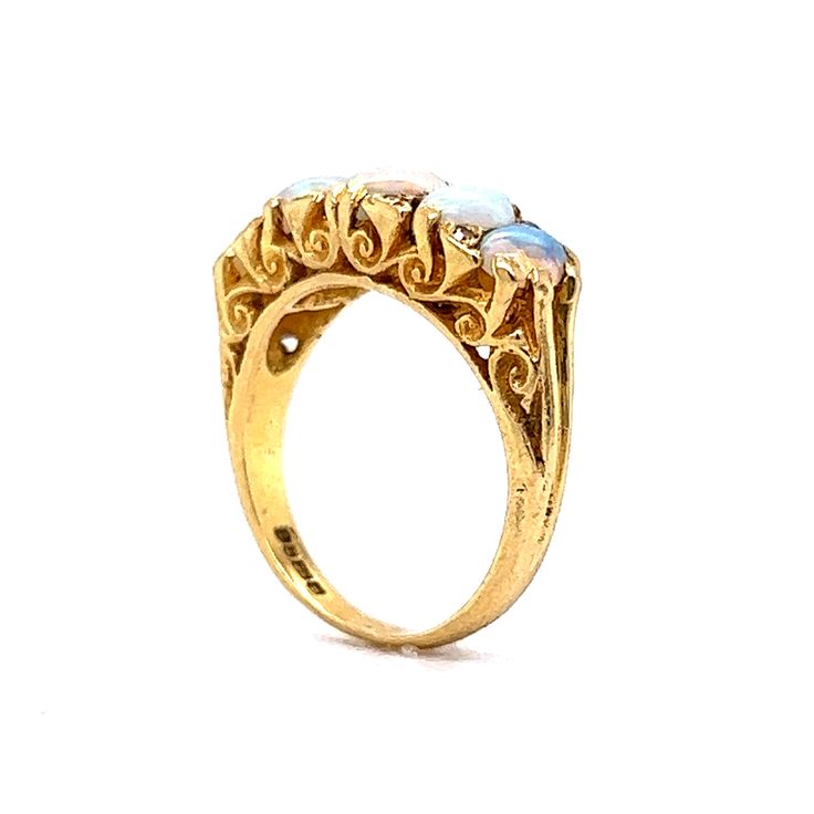 This antique Victorian era ring boasts an antique feel that will transport you to a time of glamour and luxury. Crafted from 18 karat yellow gold, this ring features beautiful cabochon opals as the primary stones and are set across the entirety of the band. The opals are complemented by eight diamonds, adding a hint of sparkle. Its timeless beauty and exceptional quality make it the perfect addition to any jewelry collection. Whether you're looking for a statement piece for a special occasion or Metal Shop, Shop Engagement Rings, Opal Ring, Victorian Era, Antique Victorian, Opal Rings, Shop Necklaces, Timeless Beauty, Timeless Pieces