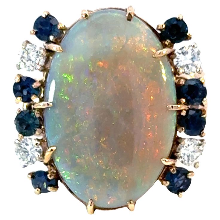 Item Specifications: Metal: 14K Yellow Gold Total Weight: 11.7 Grams Ring Size: 7.5 Gemstone Specifications: Center Gemstone: Opal Gemstone Measurements: ~22 mm x 15 mm Diamond Count: 4 Diamond Color: G-H Diamond Clarity: SI1-SI2 Total Diamond Weight: ~0.50 carats ​ ​Sapphire Count: 4 ​ ​Sapphire Carat Weight: 0.80 carats Condition: Preowned, Excellent Stamped: "14k" Opal Diamond Sapphire Ring 14k Yellow Gold Formal Multi-stone Oval Cabochon Gemstones, Oval Multi-stone Gemstones, Dazzling Oval Multi-stone Gemstones, Luxury Oval Opal Ring With 17 Jewels, Formal Multi-stone Diamond Opal Ring, Formal Multi-stone Opal Ring With Diamonds, Formal Opal Ring With Gemstone Accents, Exquisite Multi-stone Oval Opal Ring, Luxury Multi-stone Opal Ring In 14k Gold