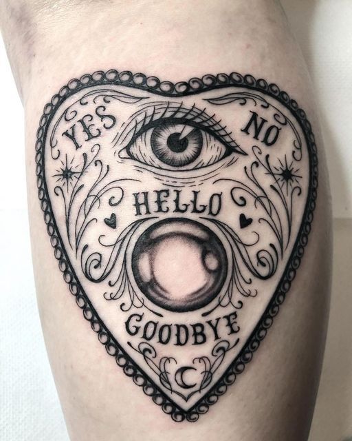 a heart tattoo with an eye and words on it