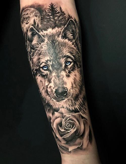 a wolf with a rose tattoo on the forearm and hand is shown in black and grey