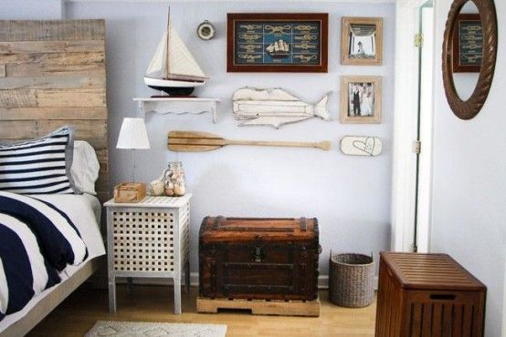 a bed room with a neatly made bed next to a dresser and two clocks on the wall