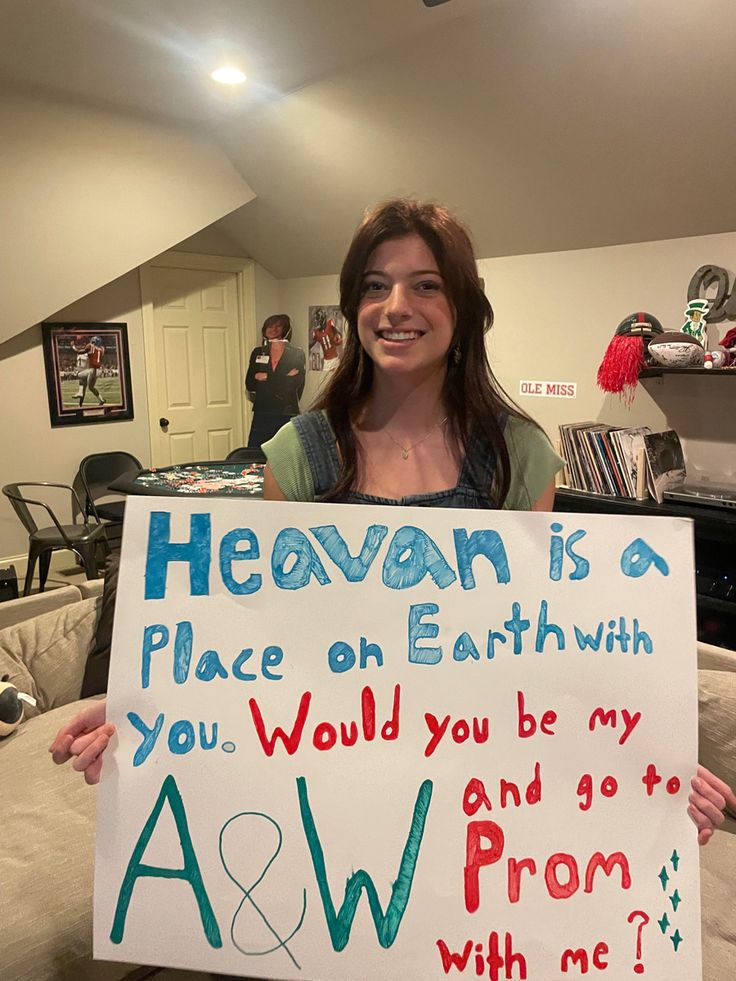 a woman holding up a sign that says heaven is a place on earth with you