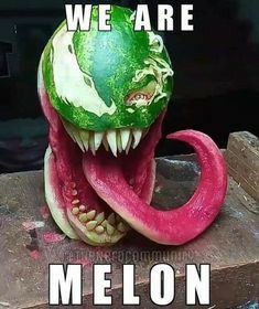 a watermelon carving of a monster's head with its mouth open