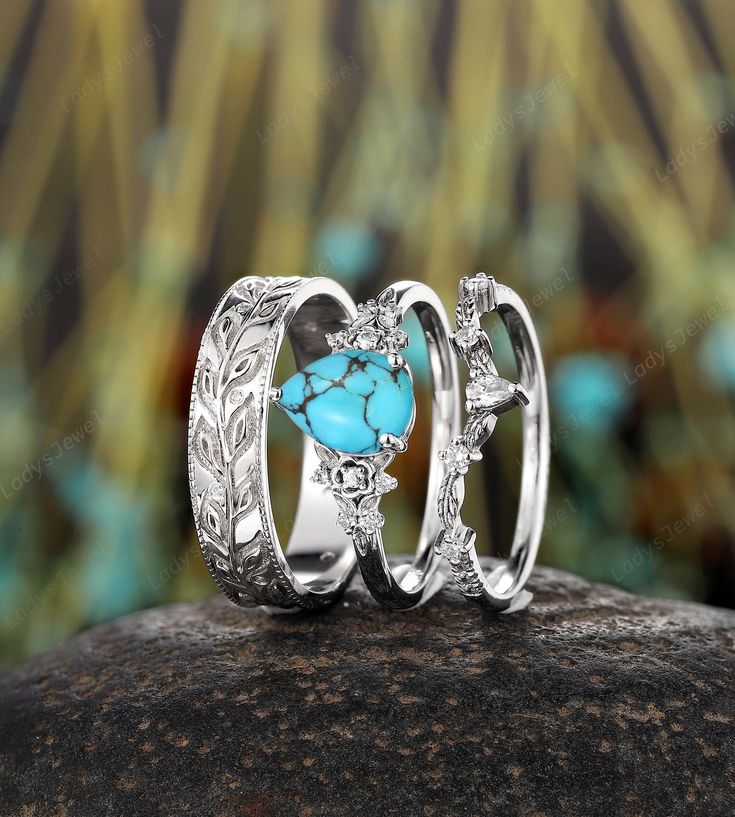 ITEM DESCRIPTION ✦Presenting our Couples Promise Ring set, a stunning representation of love and commitment.  The women's ring features a breathtaking 6x8mm pear-shaped natural mint blue turquoise as the main stone, beautifully complemented by shimmering moissanite side stones. The design is encased in a whimsical twig leaf floral setting, adding an organic and enchanting touch. For the men's band, enjoy a full eternity design featuring a twig leaf pattern, enhanced with intricate milgrain detai Silver And Turquoise Engagement Ring, Bohemian Round Promise Jewelry, Silver Turquoise Ring For Wedding, Turquoise Accent Stones Promise Ring, Turquoise Vintage Promise Ring, Turquoise Accent Stones Jewelry For Promise Ring, Bohemian Stackable Wedding Jewelry, Three-stone Aquamarine Jewelry For Gift, Three Stone Aquamarine Jewelry For Gift