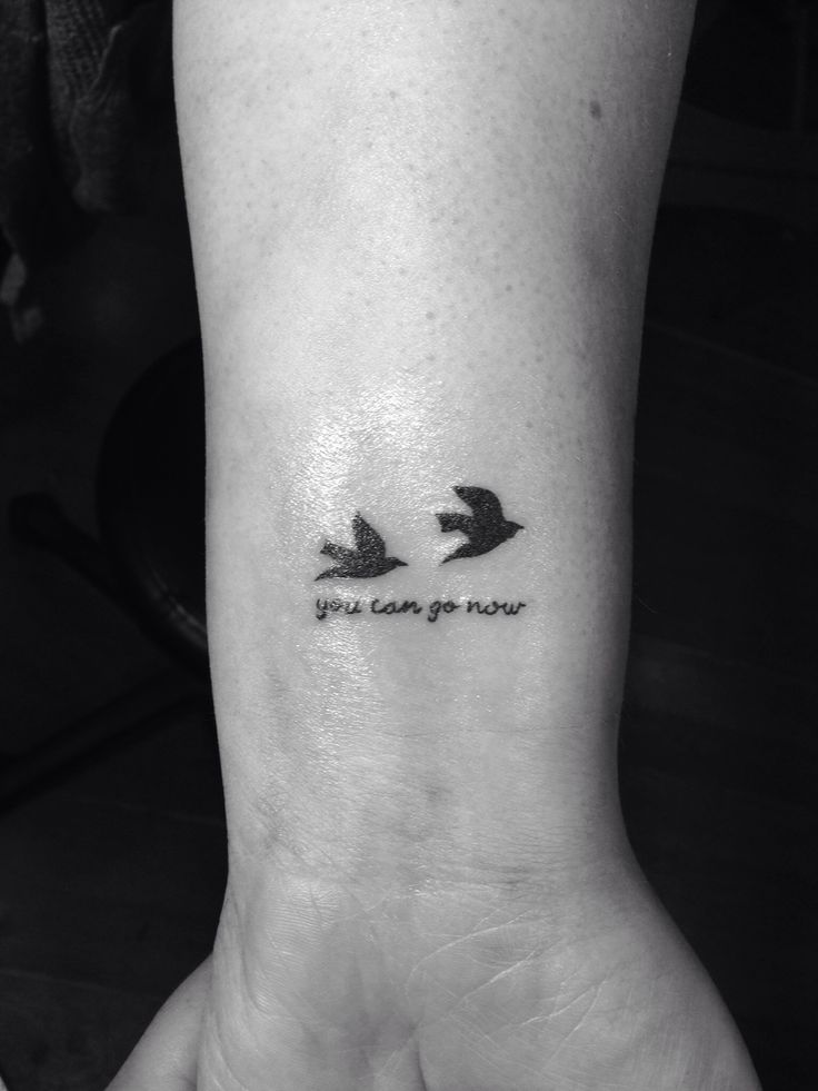 two birds with the words you can't go now on their wrist