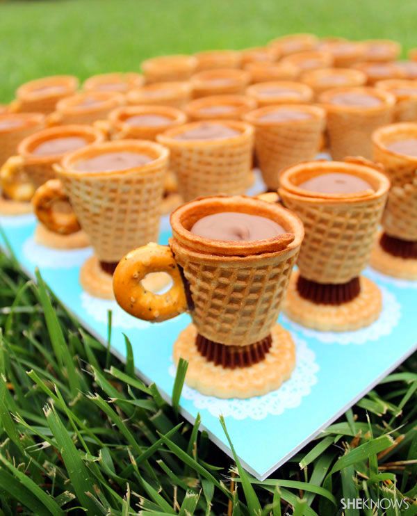 there are many ice cream cones with pretzels in them on the table together