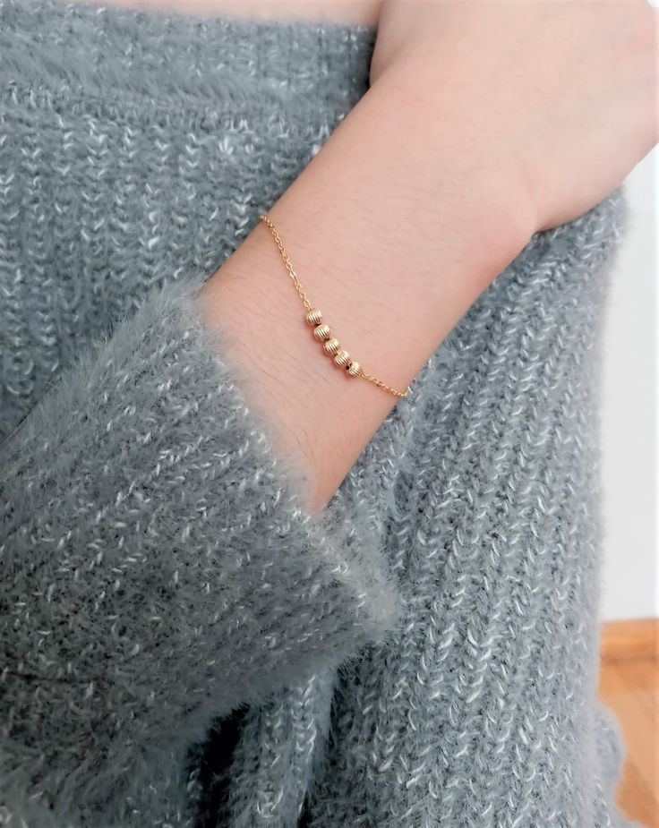 This delicate Gold Bracelet is handmade using 14k Gold Filled beads that are mobile around the chain. You can move the beads around to give it a different look. Simple and dainty, this bracelet is perfect for everyday wear. If you love a dainty fidget bracelet, you will love this one! This item consists of: - 14k Gold Filled Ball (3.0 mm) - Mobile - USA made 14k Gold-Filled - Length: 6 inches imaged (model is an XS-S depending on brand of clothing) - Extender: 3/4 inch **Please see DIY bracelet Daily Wear Bracelets For Women Gold, Daily Wear Gold Bracelet For Women, Fidget Bracelet, Real Gold Bracelet, Delicate Gold Bracelet, Traditional Hairstyle, Dainty Gold Bracelet, Gold Chain Bracelet, Beautiful Gold Necklaces