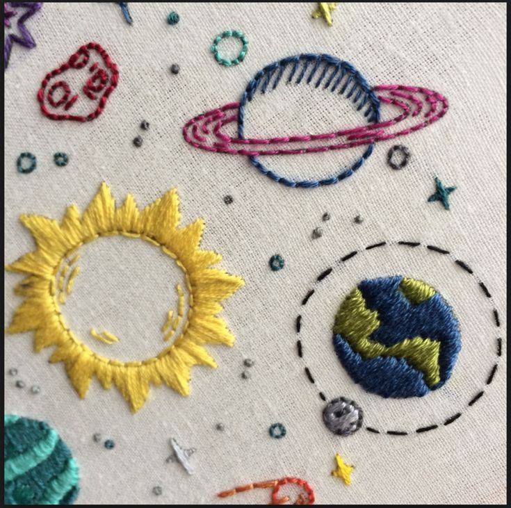 the embroidery on this pillow is made to look like space