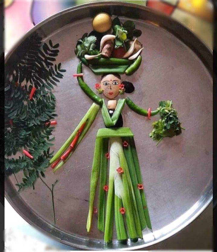 a metal tray topped with green vegetables and an image of a woman's body