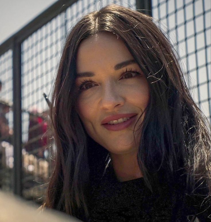 a close up of a person near a fence