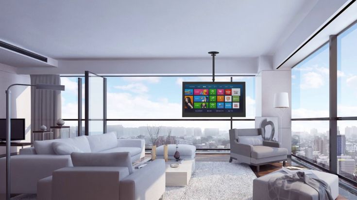 a living room filled with furniture and a flat screen tv mounted to the side of a wall