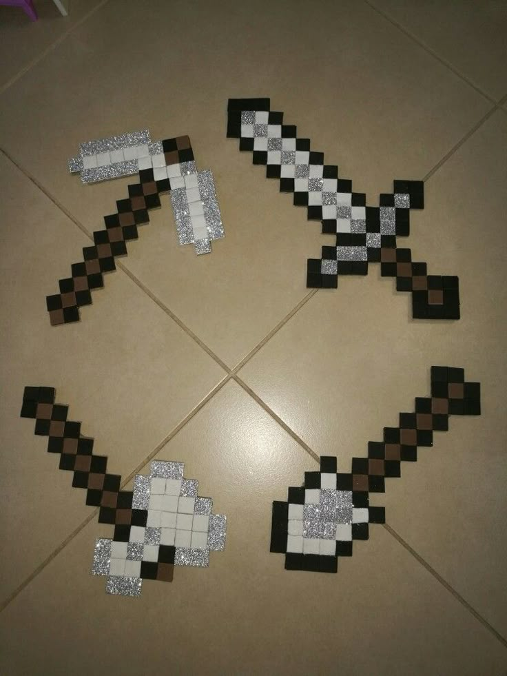 four pieces of paper made to look like minecraft characters are arranged on the floor