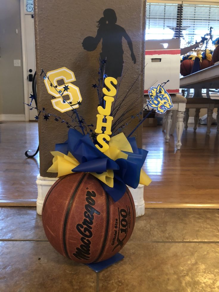 a basketball is sitting on the floor in front of a wall