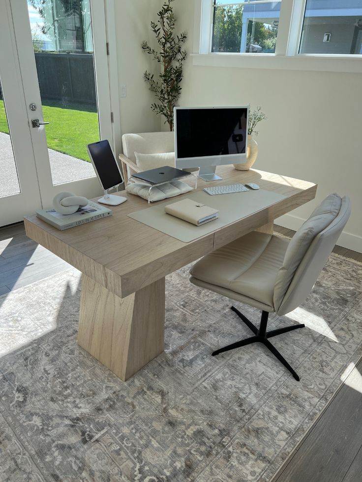 a computer desk with a laptop on top of it