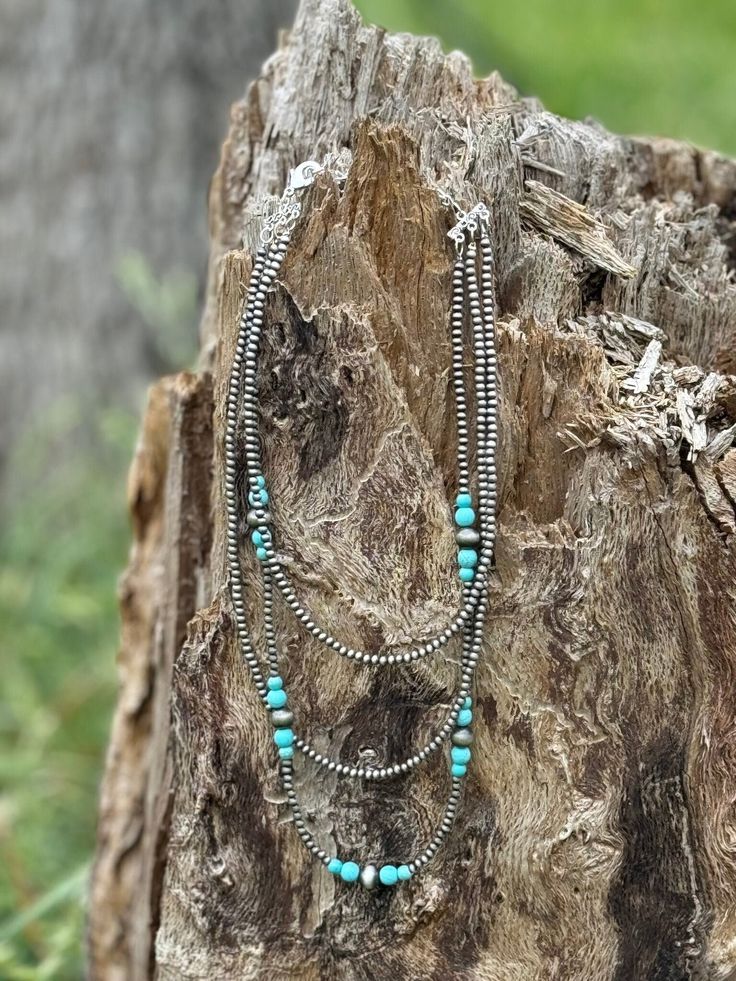 Make a statement with our Triple Layer Turquoise Bead Necklace! This necklace features three layers of vibrant turquoise and silver beads, adding a pop of color and a touch of Southwestern flair to any outfit. The layered design adds depth and dimension, creating a bold and eye-catching look. Faux silver and turquoise Cheap Blue Turquoise Southwestern Necklace, Turquoise Bohemian Beaded Necklaces For Layering, Turquoise Bohemian Beaded Necklace For Layering, Turquoise Beaded Multi-strand Layered Necklace, Turquoise Beaded Multi-strand Necklace, Bohemian Silver Turquoise Necklace With Spacer Beads, Silver Bohemian Beaded Necklaces For Layering, Turquoise Bohemian Beaded Layered Necklace, Bohemian Turquoise Beaded Layered Necklace