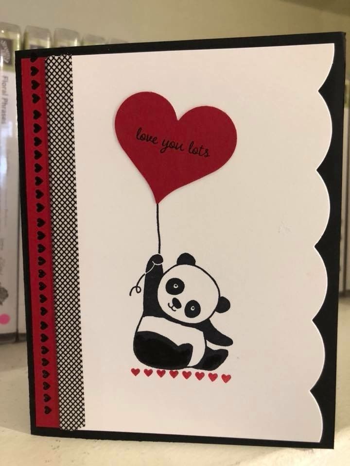 a card with a panda holding a heart shaped balloon