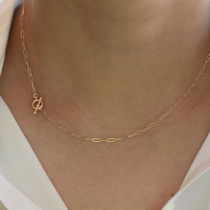 "14K Toggle Necklace, Gold Paper Clip Chain, Delicate Necklace Gold Choker. 14K gold Long Link Chain This necklace can be worn by itself or with other necklaces. *The chain, toggle clasp and all components are 14K solid yellow gold (If you order a 16\" necklace, it will be a toggle clasp plus chain will be 16\".) *The toggle clasp is about 3/8\" The model in the picture wears a 16\" necklace. Please read our policies before you place your order. https://www.etsy.com/shop/SashJewelry/policy?ref=s Minimalist Yellow Gold Toggle Necklace For Everyday, Gold Minimalist Toggle Necklace With Paperclip Chain, Minimalist Gold Toggle Necklace With Paperclip Chain, Gold Minimalist Toggle Necklace With Cable Chain, Minimalist Oval Link Toggle Necklace With Cable Chain, Minimalist Toggle Necklace With Oval Link Cable Chain, Elegant Yellow Gold Chain Link Toggle Necklace, Classic Yellow Gold Link Toggle Necklace, Gold Dainty Toggle Necklace For Everyday