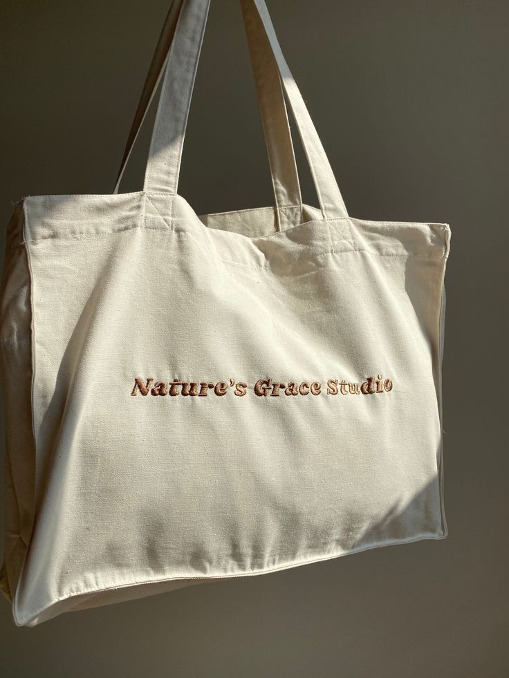 Organic Shopping tote bag Made from 100%organic cotton Luxury feel with a embroidered logo Ethically made with a transparent supply chain. For more info message me Embroidered by me :)   Washing Instructions: Washing: 30o. Bleaching no. Ironing 110o. Beige Bags With Embroidered Logo For Daily Use, Beige Rectangular Canvas Bag With Embroidered Logo, Rectangular Beige Canvas Bag With Embroidered Logo, Everyday Tote Shoulder Bag With Embroidered Logo, Beige Canvas Tote Bag With Embroidered Logo, Beige Embroidered Logo Canvas Tote Bag, Beige Canvas Bag With Embroidered Logo, Eco-friendly Embroidered Cotton Bags, Embroidered Cotton Eco-friendly Bags