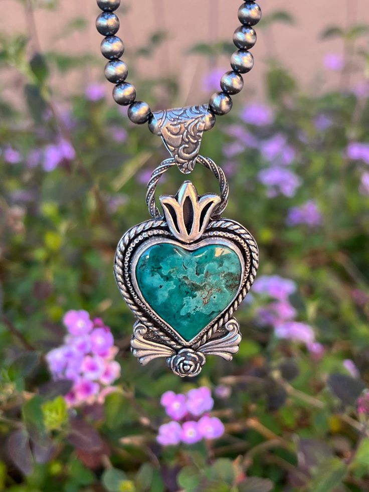 This gorgeous Hubei turquoise heart is nestled in a gorgeous sterling silver setting with a decorative boarder and elements. The pendant measures 2 1/4" x 1 1/4". This is for PENDANT only. Navajo Necklace- length of your choice can be purchased separately. Luxury Heart-shaped Turquoise Necklace, Luxury Turquoise Heart Pendant Necklace, Hubei Turquoise, Cowgirl Style Outfits, Navajo Necklace, Sterling Silver Heart Pendant, Turquoise Heart, Jewelry Antique, Silver Heart Pendant