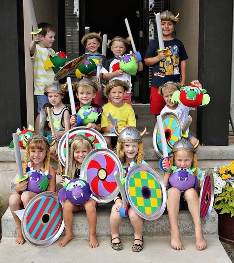 a group of children in costume posing for a photo on the front steps of a house