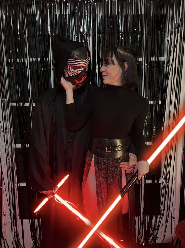 two people dressed up as darth vader and princess leisa