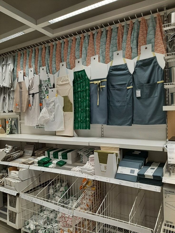 the shelves are filled with many items in baskets and bins, including laundry bags