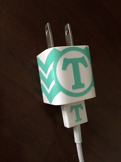 a close up of a charger plug with the letter t in green and white